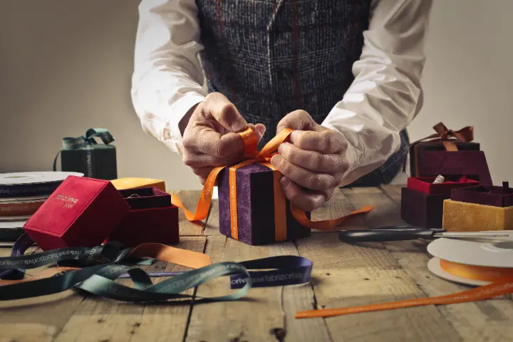Person packing customer orders in gift boxes