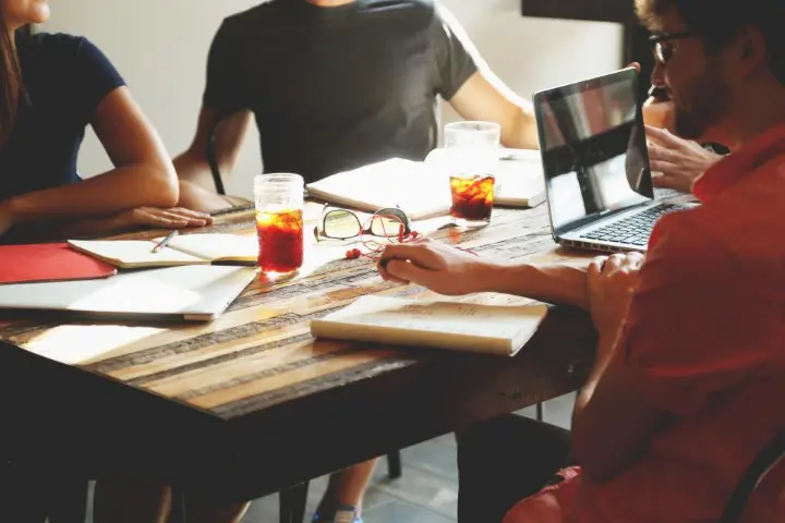 Business team in a meeting with laptops and notes