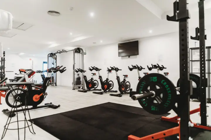 Gym interior with exercise bikes and weights